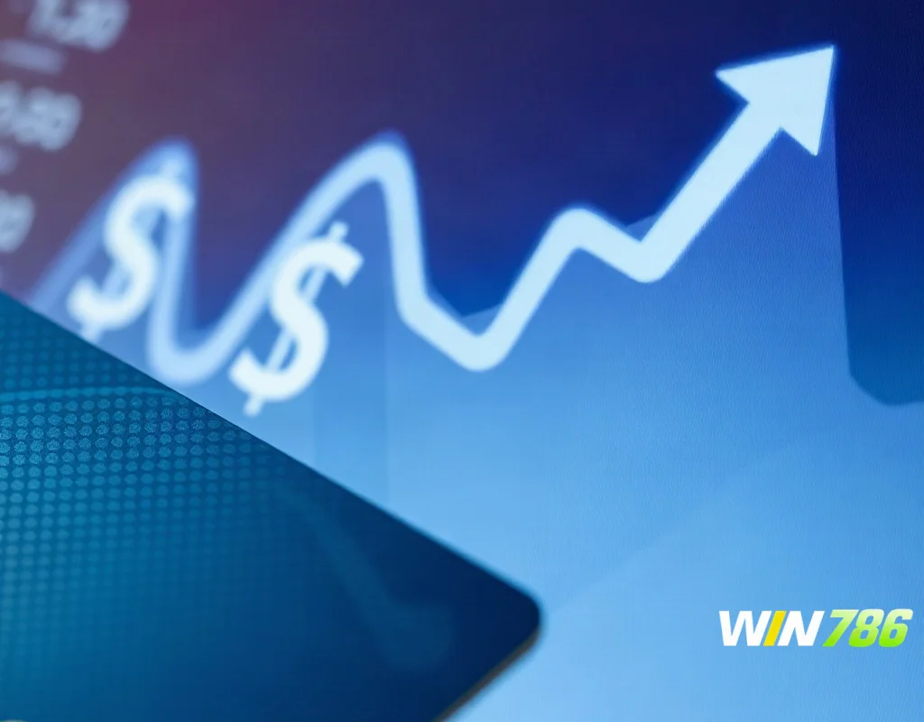 Bank card near computer with abstract money transfer graphic